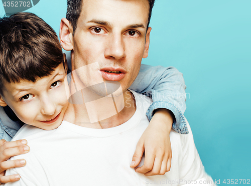 Image of young pretty man model with little cute son playing together, lifestyle modern people concept, family male