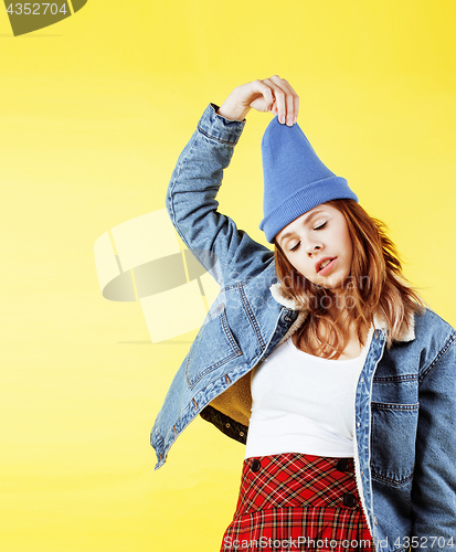 Image of lifestyle people concept: pretty young school teenage girl having fun happy smiling on yellow background