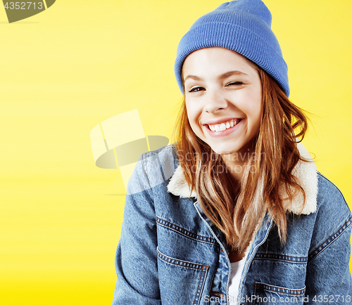 Image of lifestyle people concept: pretty young school teenage girl having fun happy smiling on yellow background
