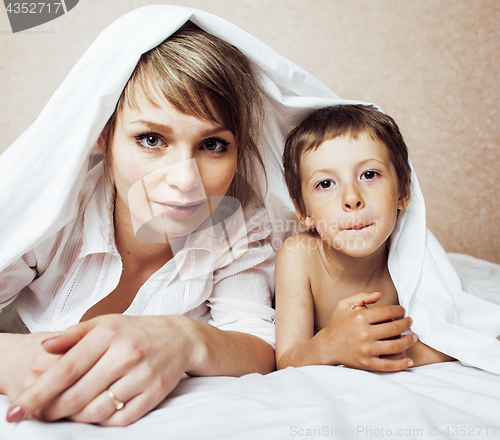 Image of young blond woman with little boy in bed, mother and son, happy familyyoung blond woman with little boy in bed, mother and son, happy family 