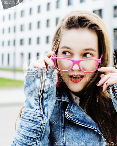 Image of young pretty brunette business woman posing against modern building, lifestyle people concept 