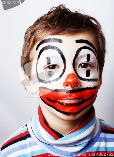 Image of little cute boy with facepaint like clown, pantomimic expression