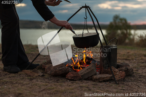 Image of Preparing food on campfire