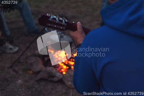 Image of guitar near the campfire