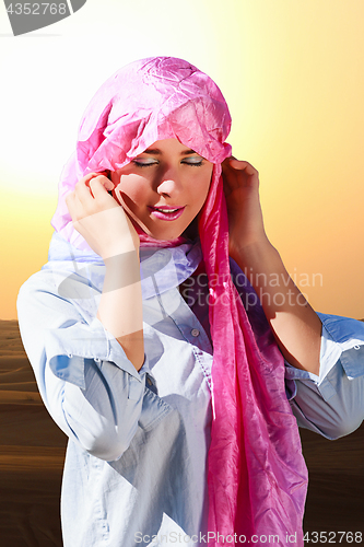 Image of Arabia style portrait of a woman in the desert.