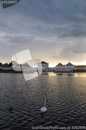 Image of Dramatic scenery of post storm sunset of Nymphenburg palace in Munich Germany.