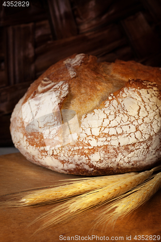 Image of Homemade bread loaf on old cutting board