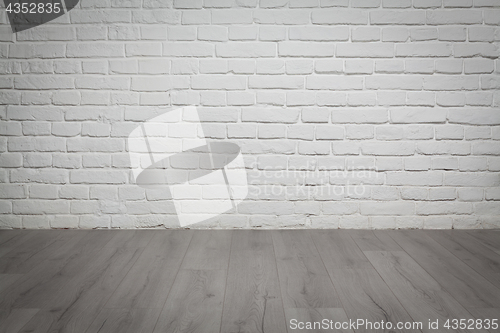 Image of Old white brick wall and wood floor background