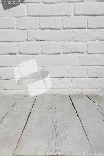 Image of Old white brick wall and wood floor background