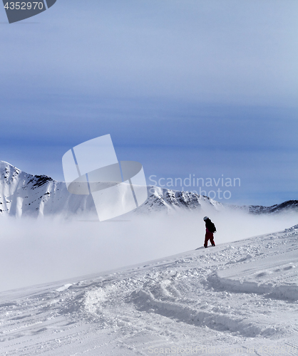 Image of Snowboarder on off-piste slope with newly fallen snow