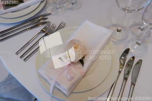 Image of Spring table settings with fresh flower, napkin and silverware. Holidays background. Selective Focus.