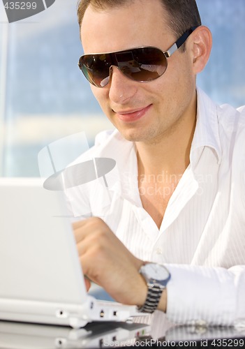 Image of businessman on leisure with laptop