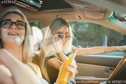 Image of The young women in the car smiling