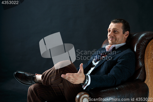 Image of Businessman sitting on an armchair