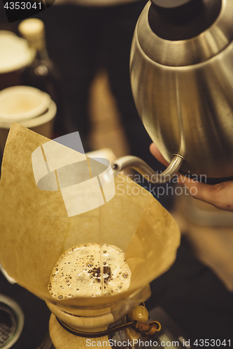 Image of Barista pouring water to coffee