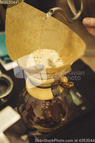 Image of Barista pouring water to coffee