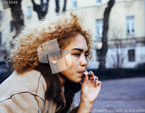 Image of young pretty girl teenage outside smoking cigarette close up, lo