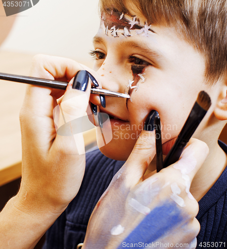 Image of little cute child making facepaint on birthday party, zombie Apo