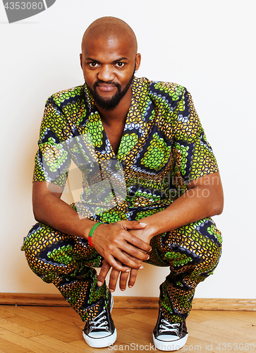 Image of portrait of young handsome african man wearing bright green nati