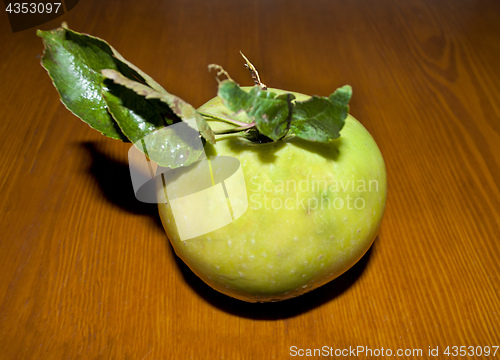 Image of green apple with leaves
