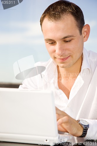 Image of businessman on leisure with laptop