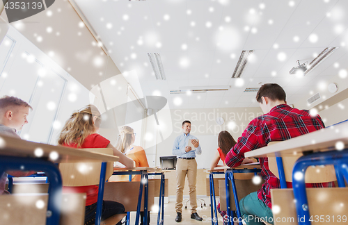 Image of group of students and teacher with papers or tests