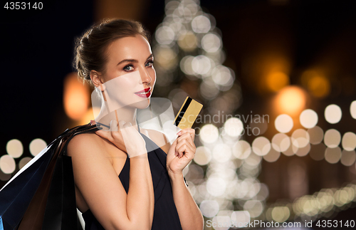 Image of woman with credit card and shopping bags