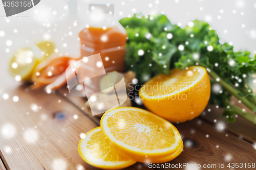 Image of orange, bottle of carrot juice and vegetables