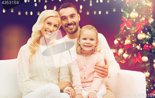 Image of happy family over christmas tree