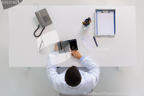 Image of doctor with tablet pc and prescription at clinic