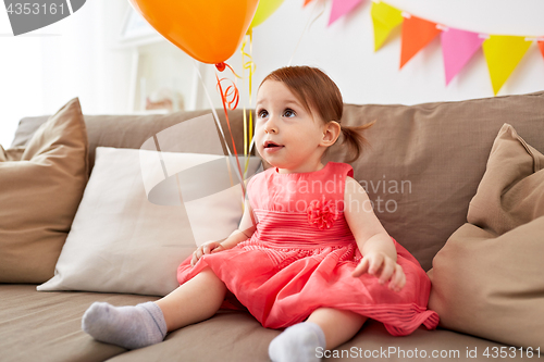 Image of happy baby girl on birthday party at home