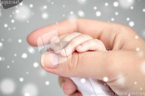 Image of close up of mother and newborn baby hands