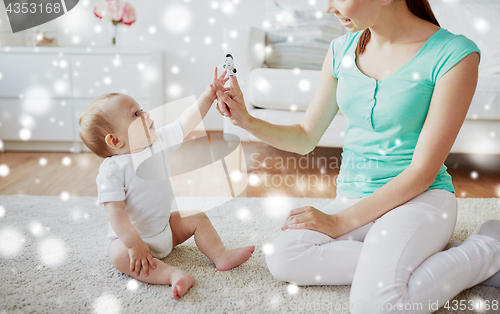 Image of happy mother and baby playing at home