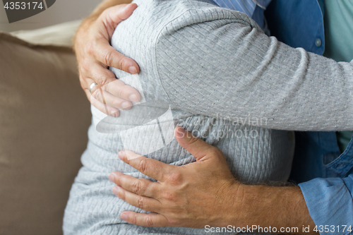 Image of close up of married senior couple hugging