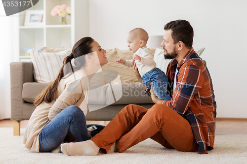 Image of happy family with baby having fun at home