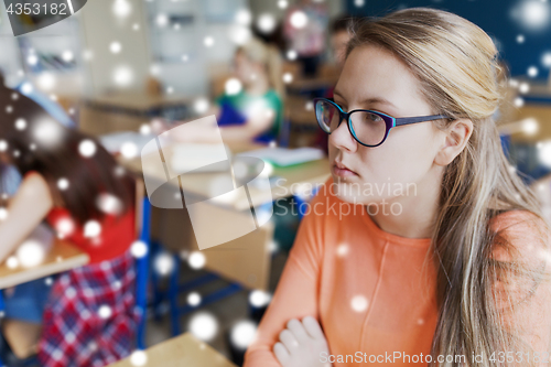 Image of student girl in eyeglasses at school lesson