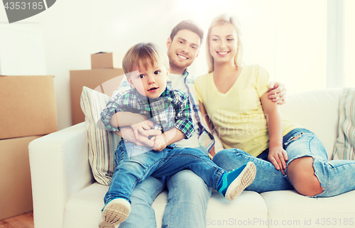 Image of happy family with boxes moving to new home