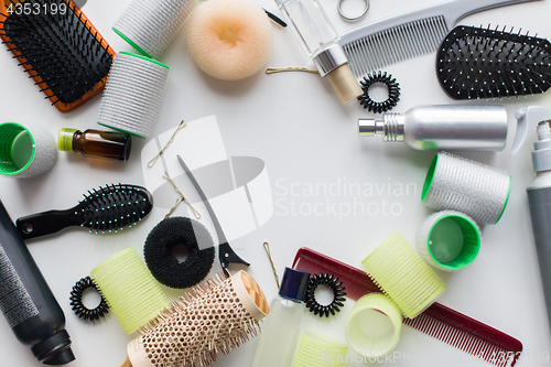 Image of hair brushes, styling sprays, curlers and pins