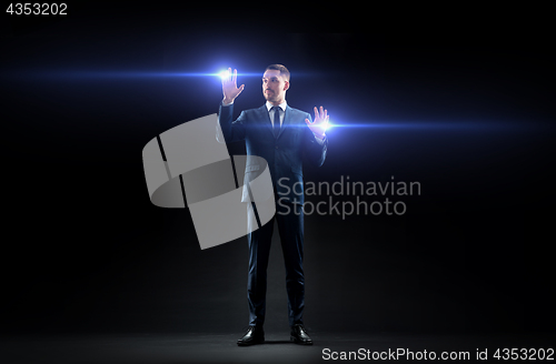 Image of businessman with laser light over black