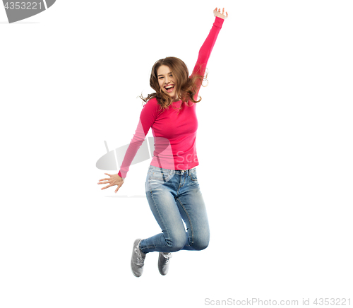 Image of smiling young woman jumping in air