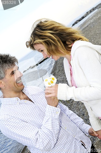 Image of Mature romantic couple with flowers