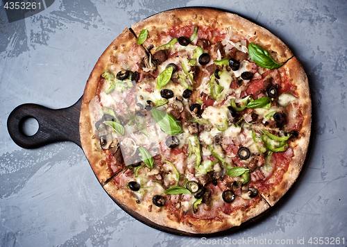 Image of Delicious Pizza with Ham, Olives and Jalapenos