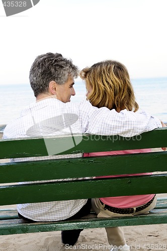 Image of Mature romantic couple on a bench