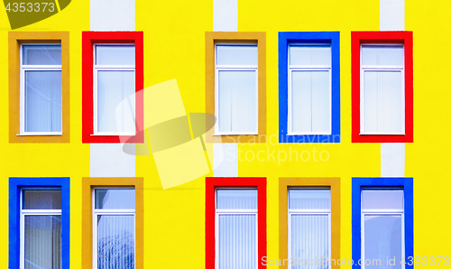 Image of Yellow Wall With Colorful Windows