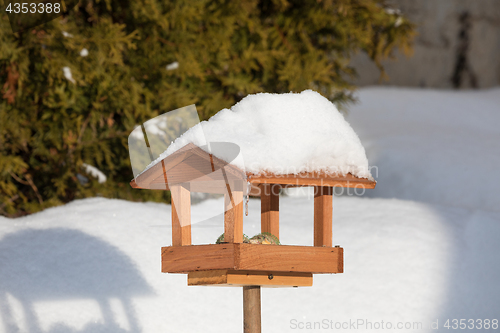 Image of simple birdhouse in winter garden