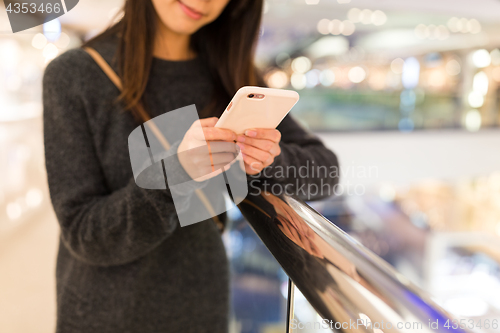 Image of Woman working on cellphone