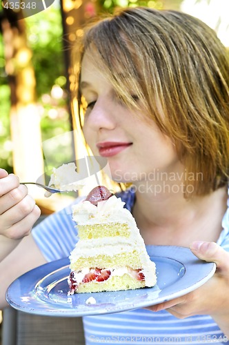 Image of Girl eating a cake