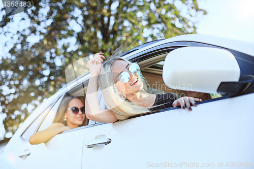 Image of The young women in the car smiling