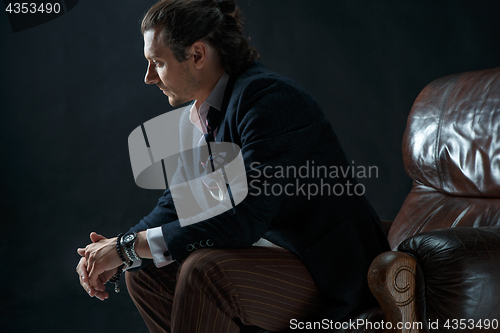 Image of Businessman sitting on an armchair