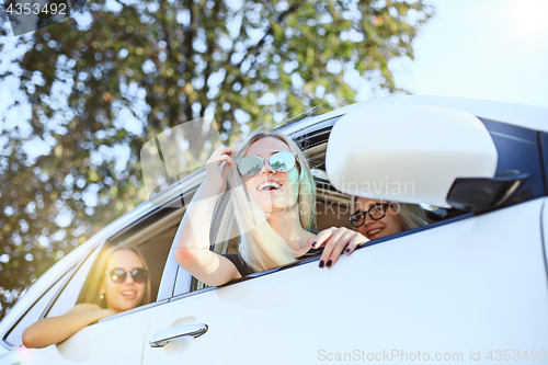 Image of The young women in the car smiling